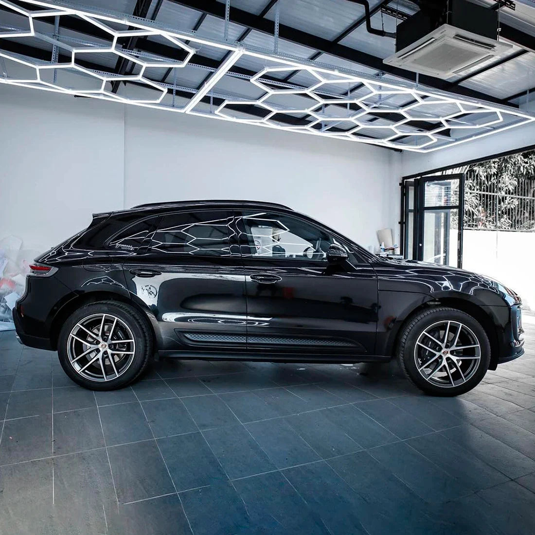 Porsche side view in Black Gloss Vinyl Wrap.