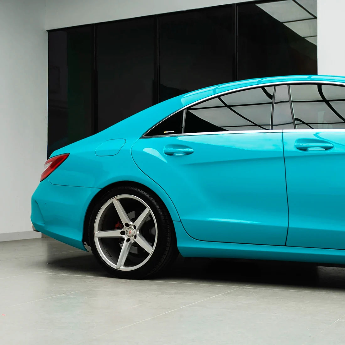 Mercedes-Benz quarter panel in High Gloss Rolling Sea Vinyl Wrap finish.