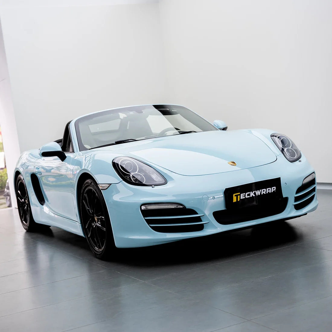 High Gloss Bali Blue Vinyl Wrap on Porsche Front Angled View