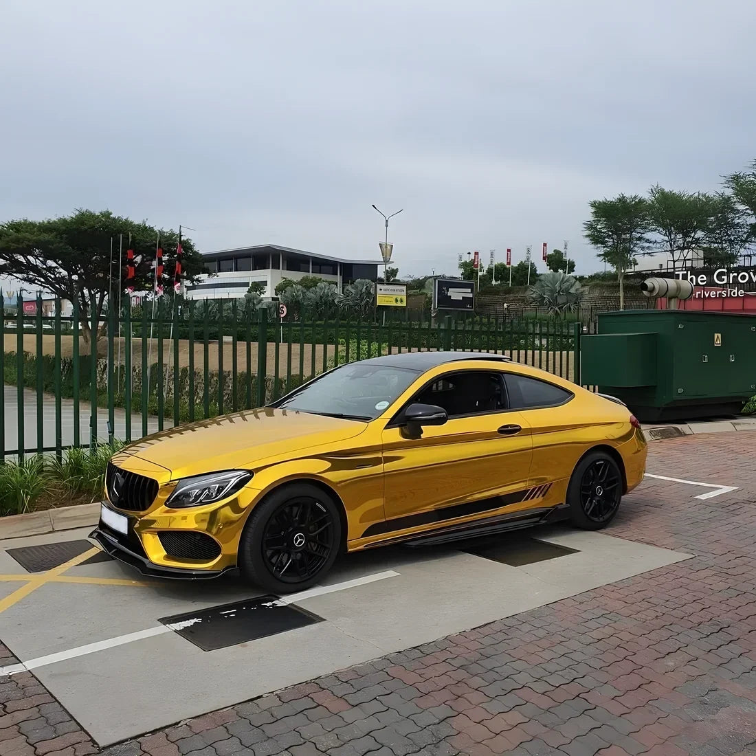 Yellow Gold Mirror Chrome vinyl wrap on Mercedes with reflective golden finish.