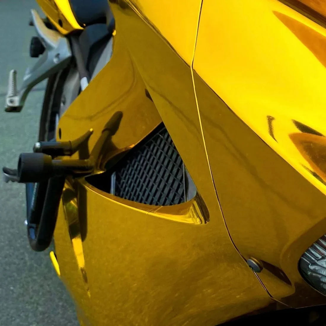 Golden motorcycle featuring a vinyl wrap Mirror Chrome Yellow Gold.