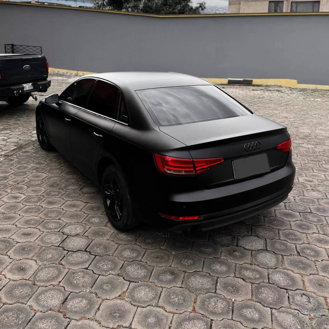 A satin matte black vinyl wrap on Audi