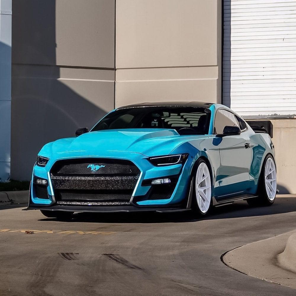 Sleek sports car wrapped in Teckwrap Gloss Caribbean Blue .