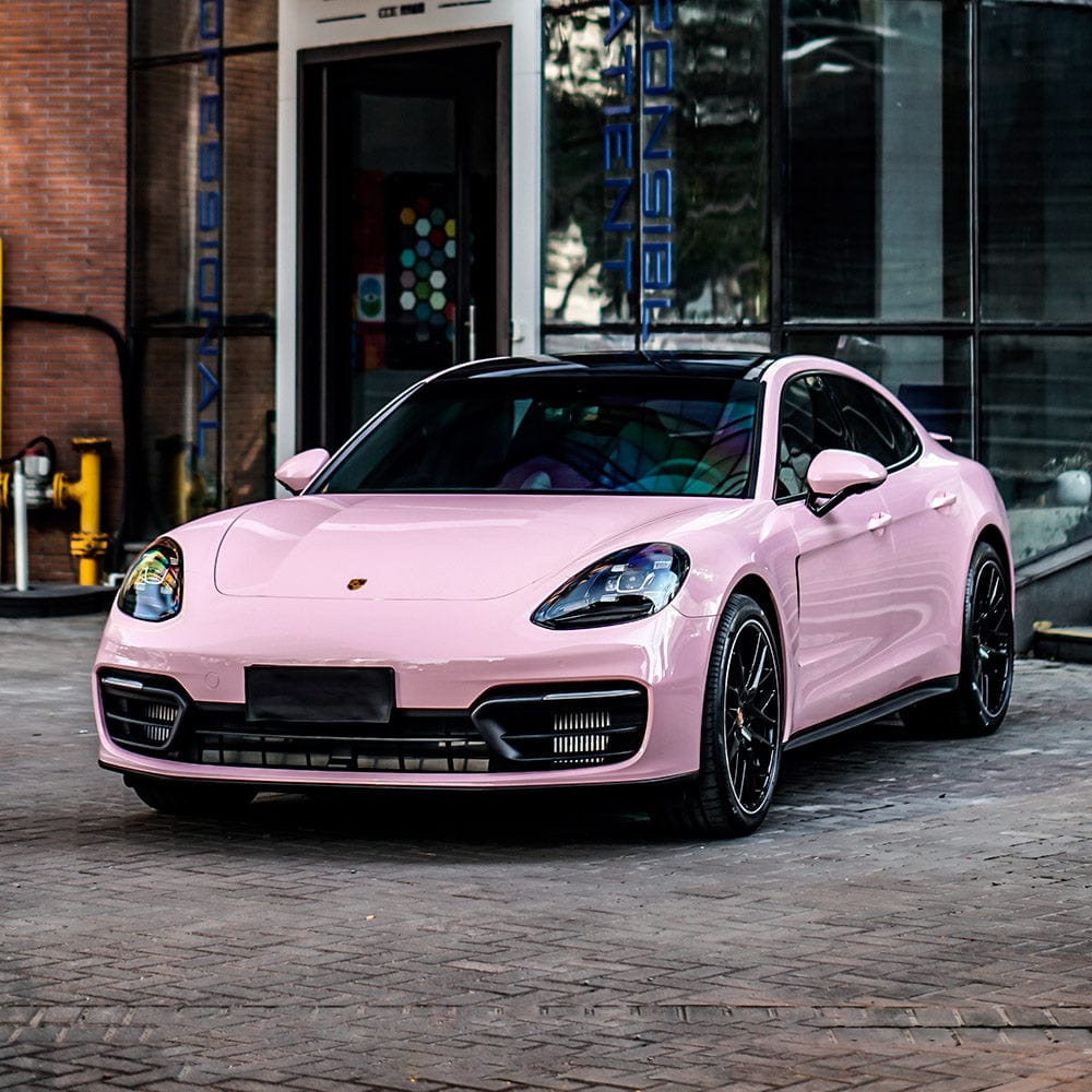 Porsche wrapped in TeckWrap Millennial Pink Gloss Vinyl, demonstrating a sophisticated, sleek appearance with a vibrant pastel pink finish.