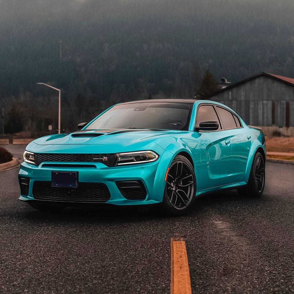 Dodge Charger Wrapped with TeckWrap Sea Turquoise Gloss Vinyl (RB16-HD) - Dynamic outdoor image of a Dodge Charger wrapped in striking sea turquoise gloss vinyl, emphasizing the bold, shiny, and sophisticated appearance of the wrap.