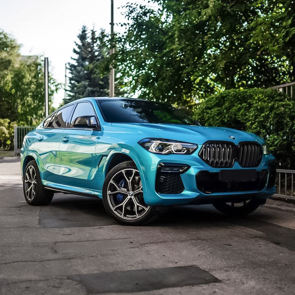 BMW Wrapped in TeckWrap Sea Turquoise Gloss Vinyl (RB16-HD) - Front and side view of a sleek BMW SUV showcasing the brilliant turquoise gloss vinyl wrap, accentuating the car's curves and luxurious aesthetic.