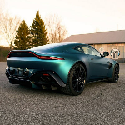 Rear angle view of an Aston Martin in Jewel Green Satin Metallic vinyl wrap