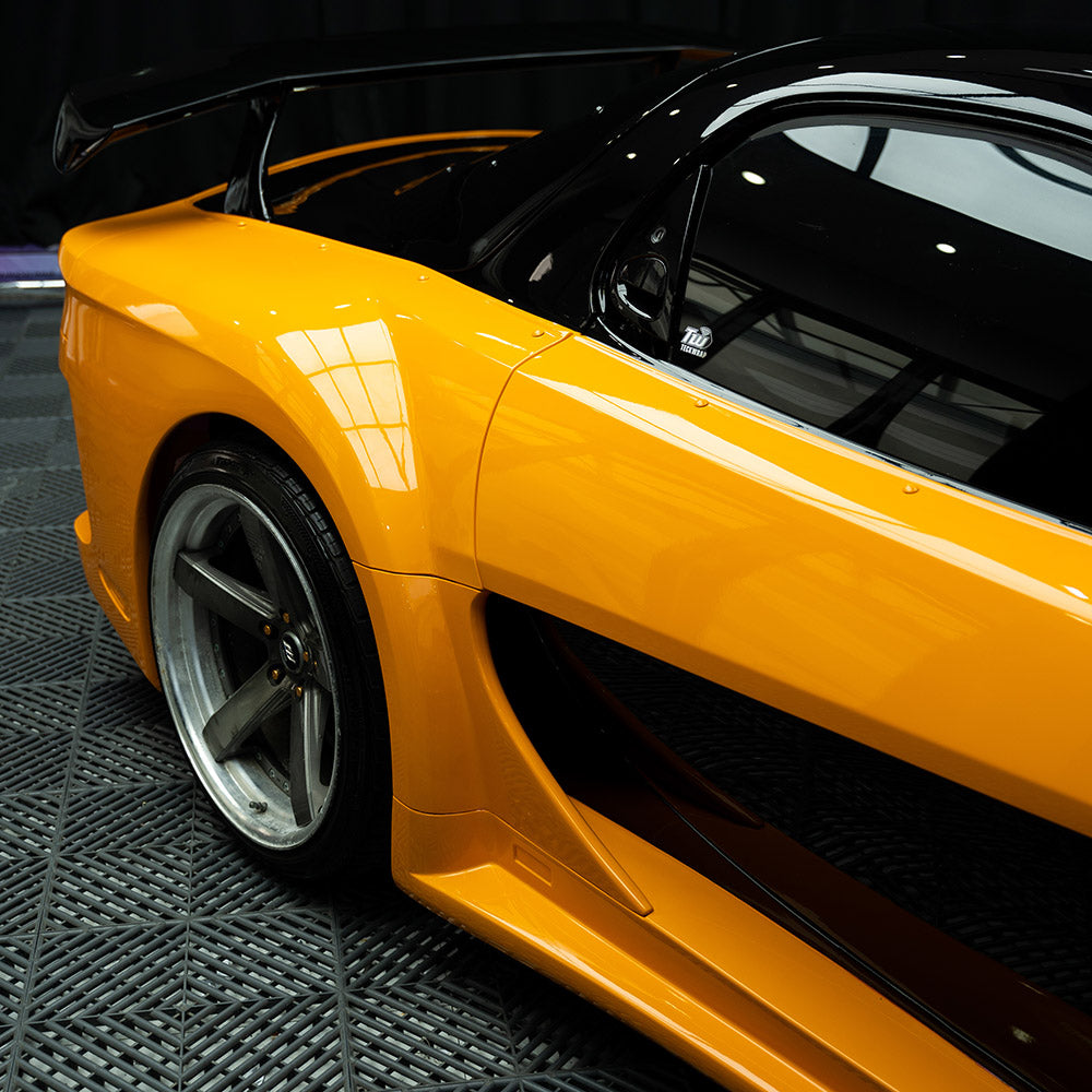 Rear-side angle of vehicle in High Gloss Papaya Orange Vinyl Wrap