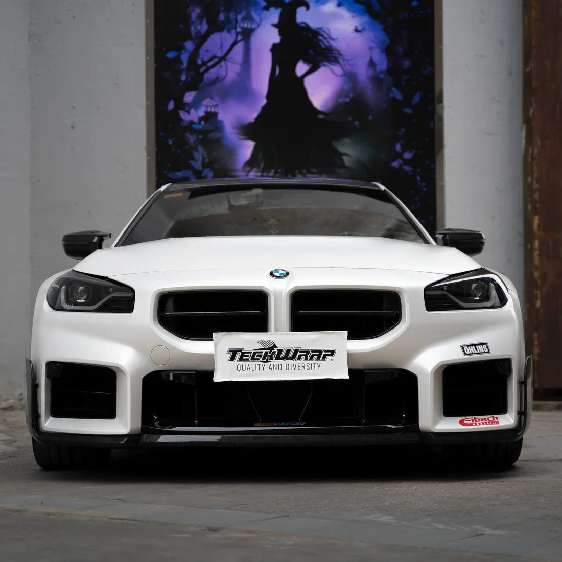 A white satin matte vinyl wrap on BMW M2