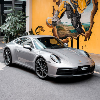 A full side view of a Porsche sports car Gloss Metallic Dolomite Silver Vinyl Wrap