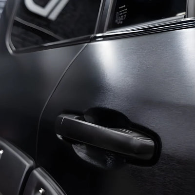 Carbon Brushed Black Vinyl Wrap on curved body panel.