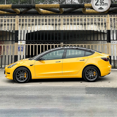 Tesla side view in Yellow high gloss ultra cab taxi vinyl finish.