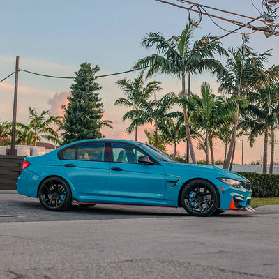 BMW side view in High Gloss Rolling Sea Vinyl Wrap