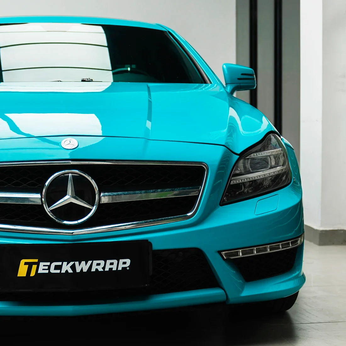 Mercedes-Benz front closeup in High Gloss Rolling Sea Vinyl Wrap finish.