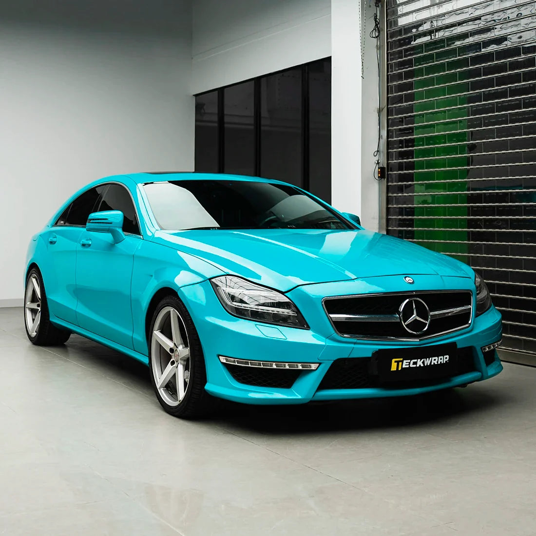 Mercedes-Benz three-fourth view in Rolling Sea Teal high super gloss vinyl finish.
