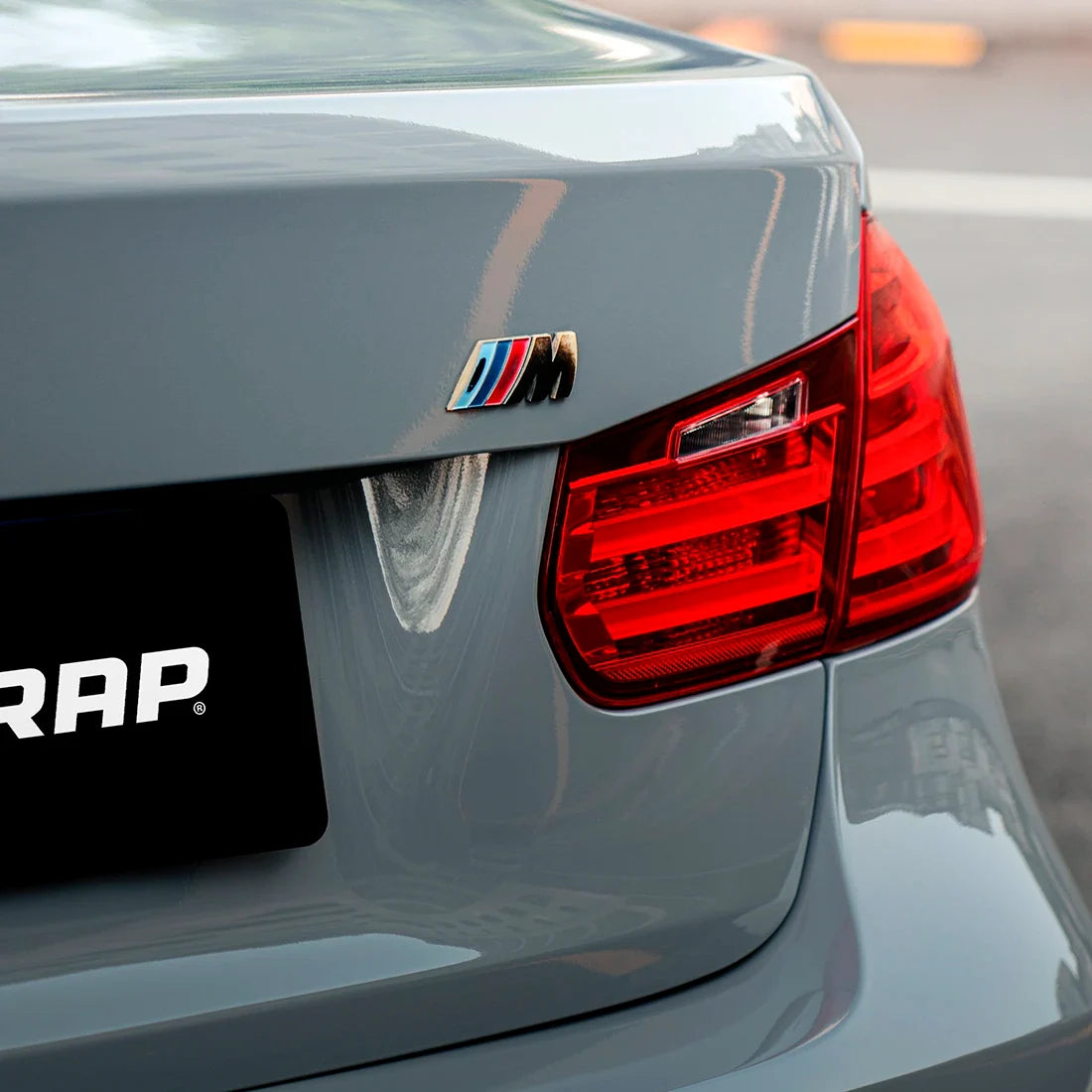 BMW rear taillight and M badge on High Gloss True Nardo Grey Vinyl Wrap