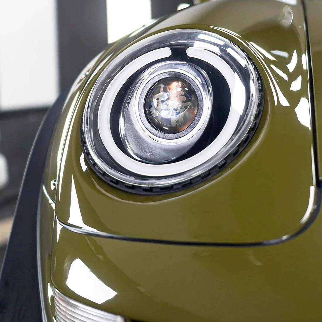 High Gloss Khaki Green Vinyl Wrap on Porsche Headlight Close-Up