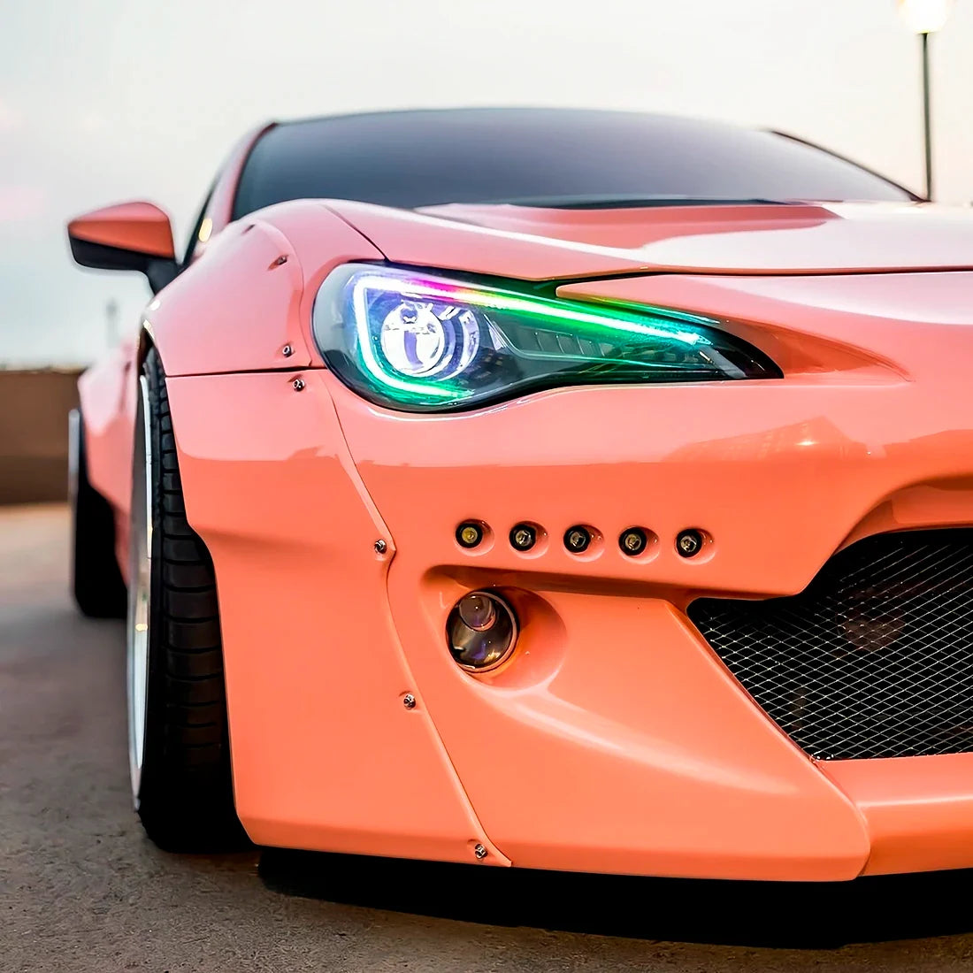 High Gloss Amber Rose Vinyl Wrap on Supra Headlight Close-Up