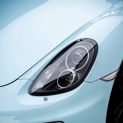 High Gloss Bali Blue Vinyl Wrap on Porsche Headlight Close-Up