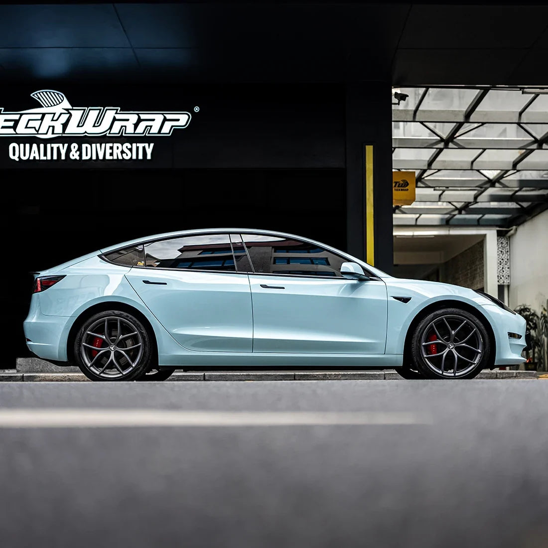 High Gloss Bali Blue Vinyl Wrap on Tesla Side View