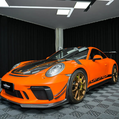 High Gloss Tangerine Orange Vinyl Wrap on Porsche Front Angle View