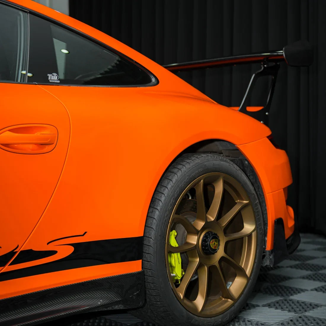 High Gloss Tangerine Orange Vinyl Wrap on Porsche Side Angle View