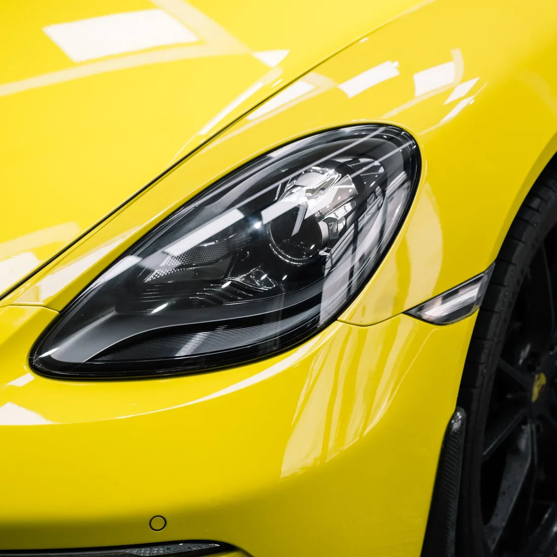 High Gloss Louvre Yellow Vinyl Wrap on Porsche Front Close-Up