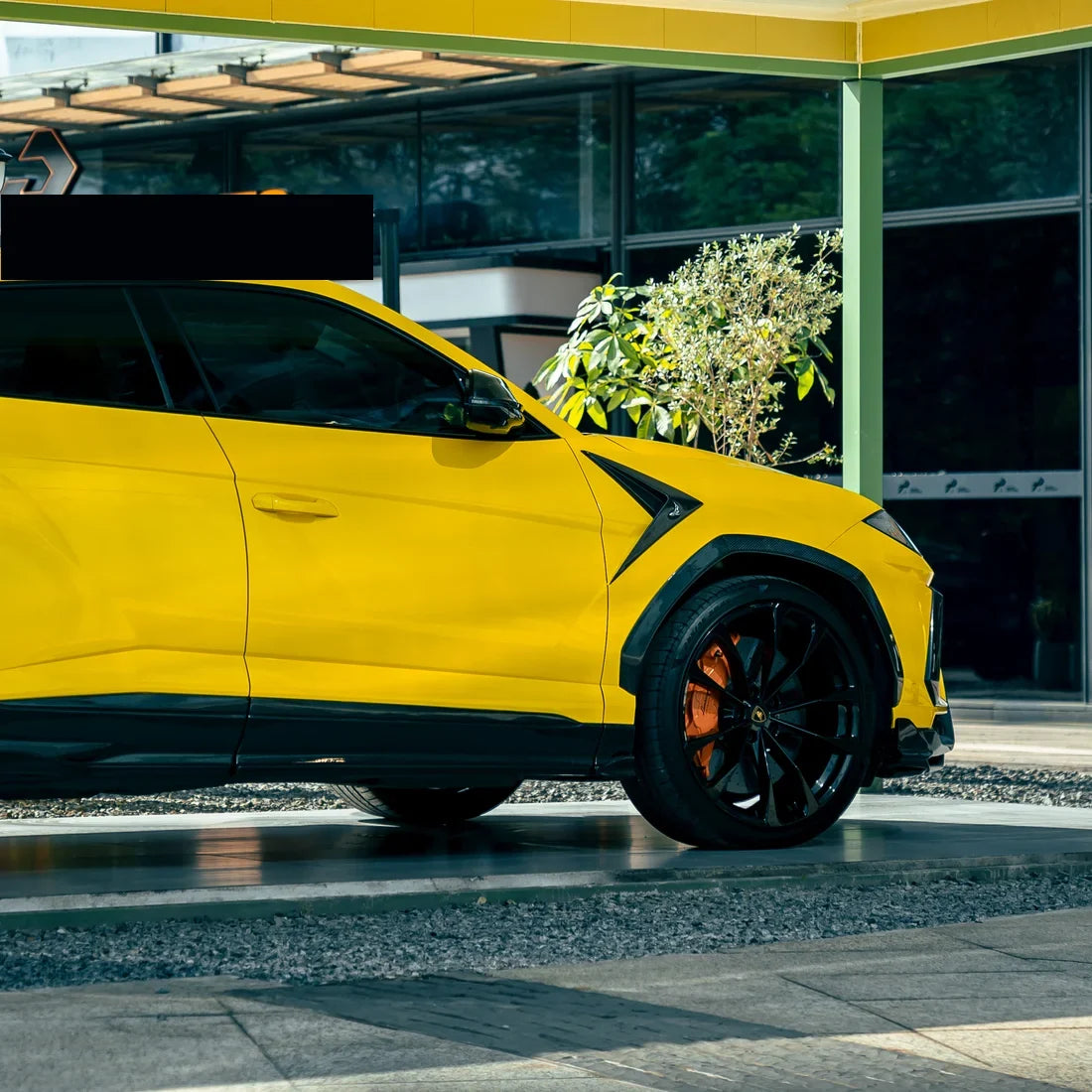 High Gloss Sunray Yellow Vinyl Wrap on Lamborghini Urus Wheel Close-Up