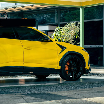 High Gloss Sunray Yellow Vinyl Wrap on Lamborghini Urus Wheel Close-Up