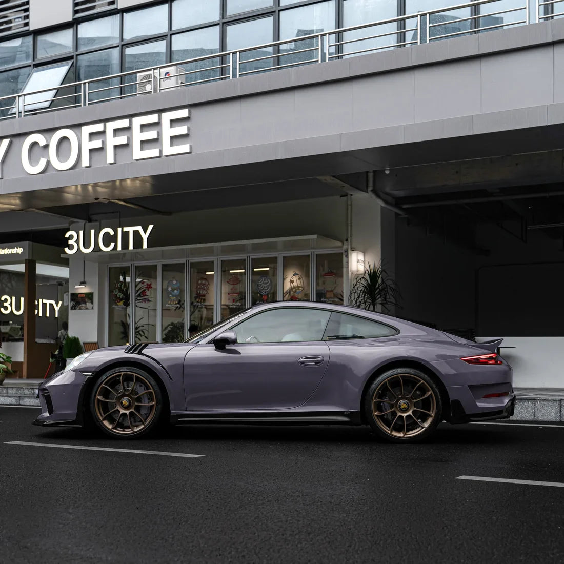 Porsche with a High Gloss Dusky Grape Vinyl Wrap finish.