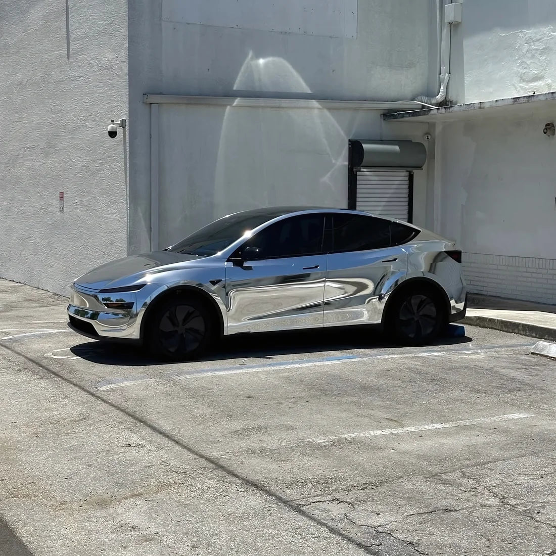 Tesla wrapped in Chrome White Gold Vinyl Wrap.
