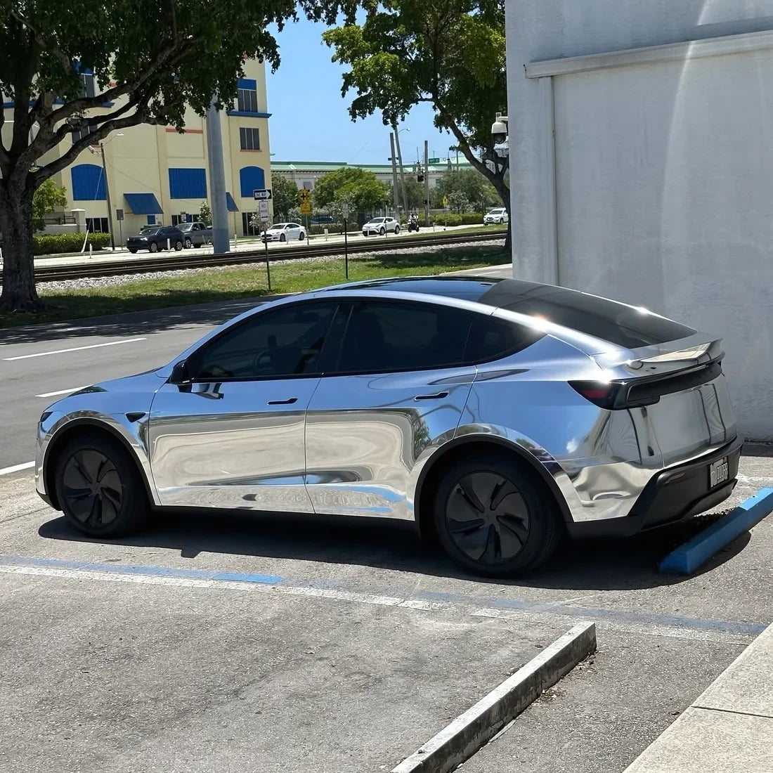 Chrome White Gold Vinyl Wrap Tesla with side view.