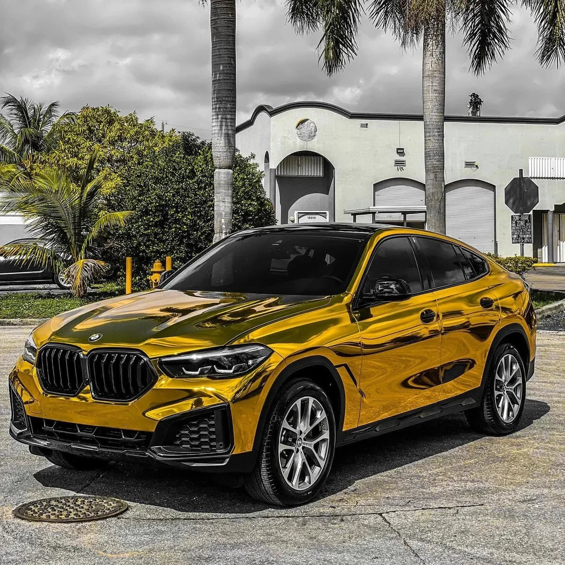 BMW wrapped in a glossy Yellow Gold Mirror Chrome vinyl wrap.