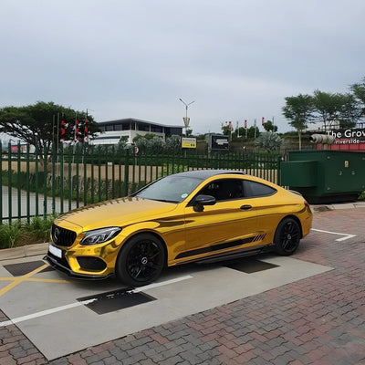 Yellow Gold Mirror Chrome vinyl wrap on Mercedes with reflective golden finish.
