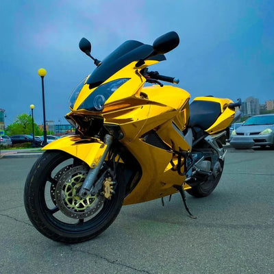 Mirror Chrome Yellow Gold vinyl wrap on motorcycle with golden finish.