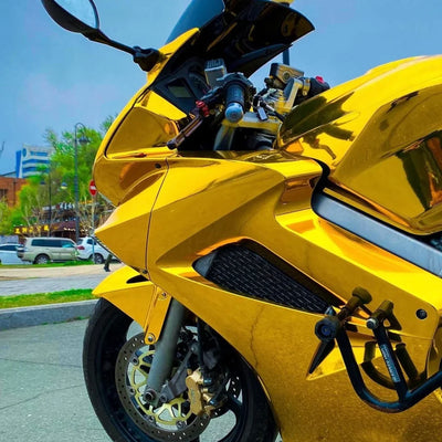 Yellow Gold Mirror Chrome vinyl wrap motorcycle a smooth reflective body.