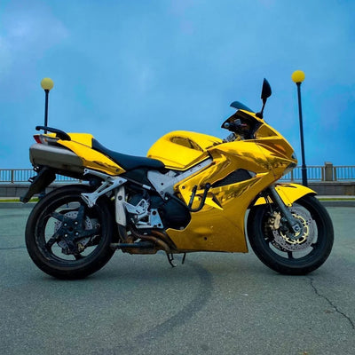 Yellow Gold Mirror Chrome vinyl wrap motorcycle featuring a reflective body.
