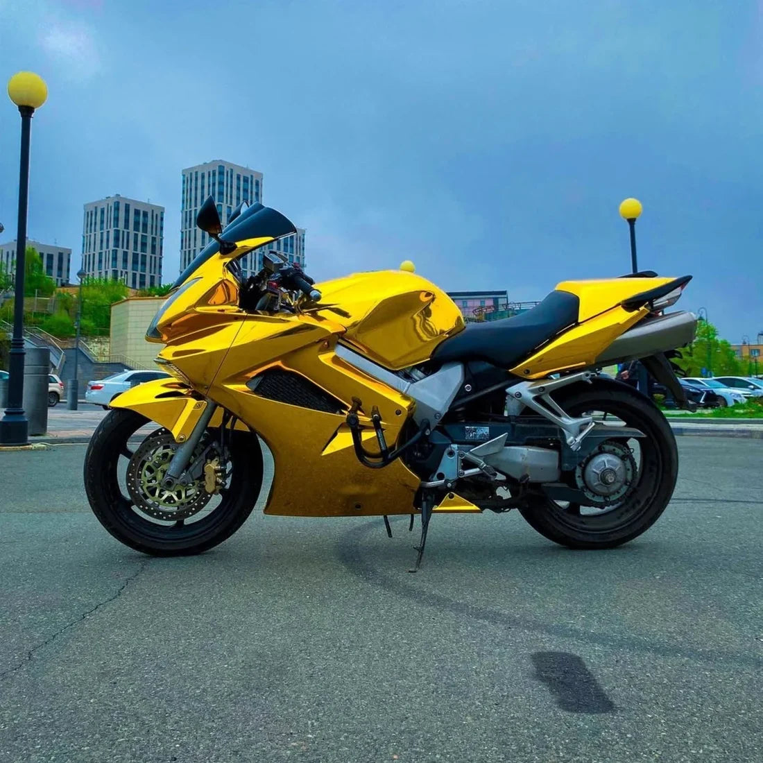 Mirror Chrome Yellow Gold motorcycle with a bright metallic vinyl wrap.