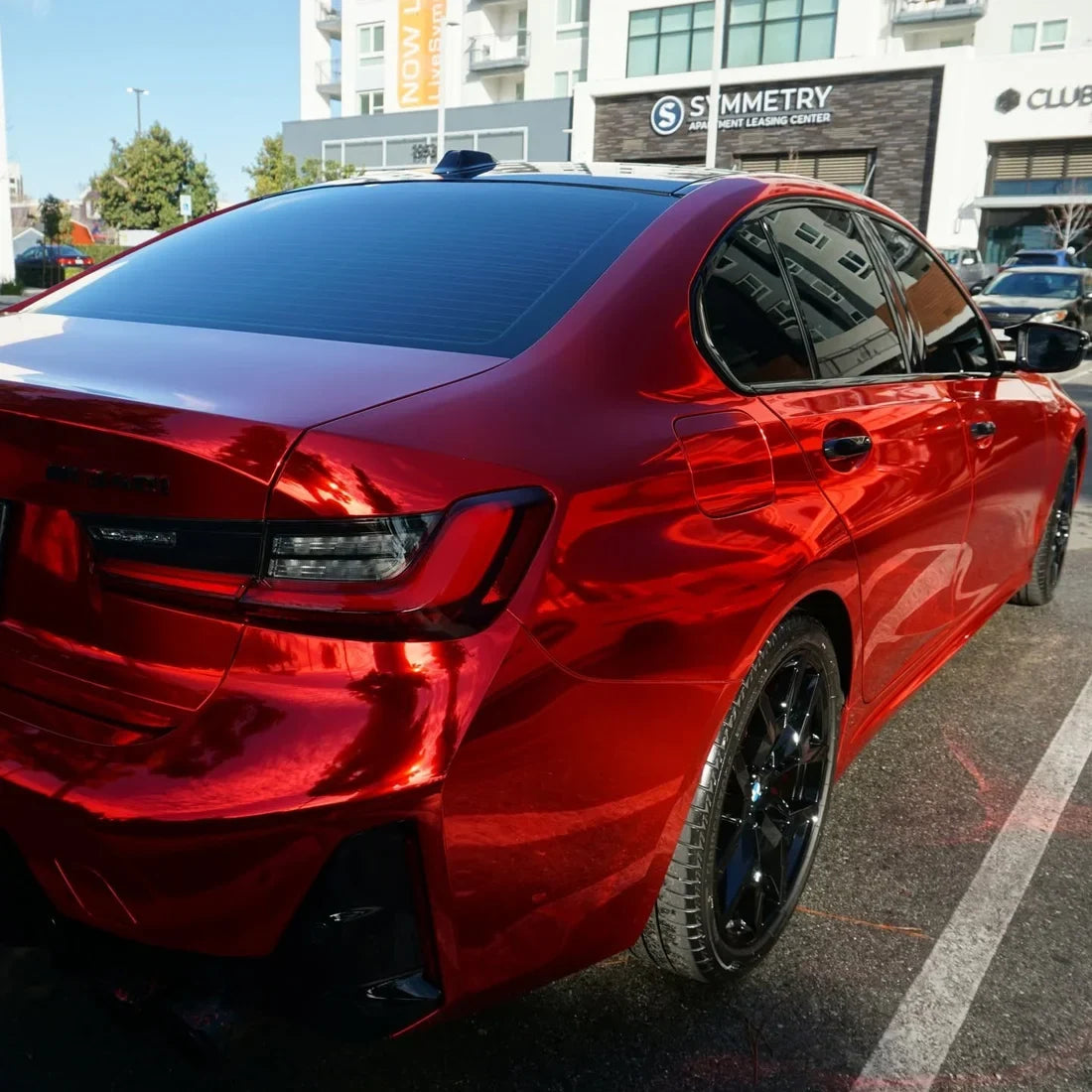 BMW showcasing a Cherry Red Mirror Chrome vinyl wrap.