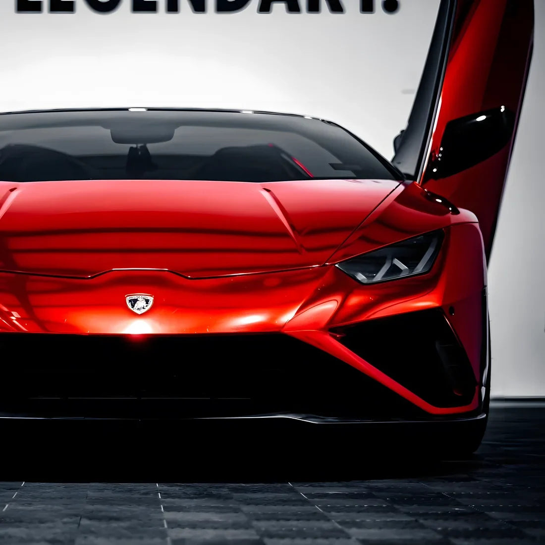 Lamborghini finished in Cherry Red Mirror Chrome vinyl wrap with a rich red shine.
