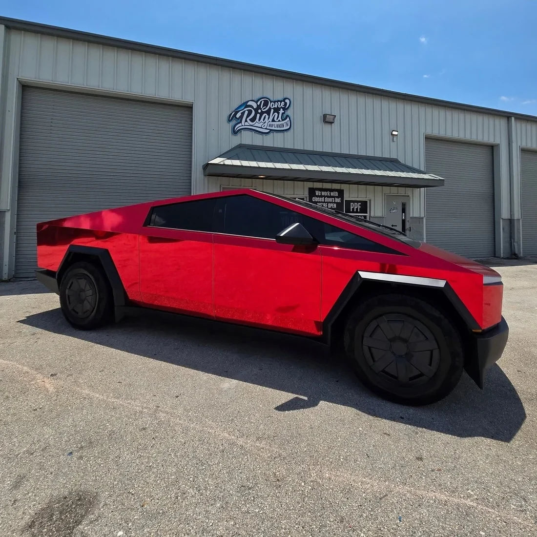 Tesla wrapped in Cherry Red Mirror Chrome vinyl wrap with a vibrant red sheen.