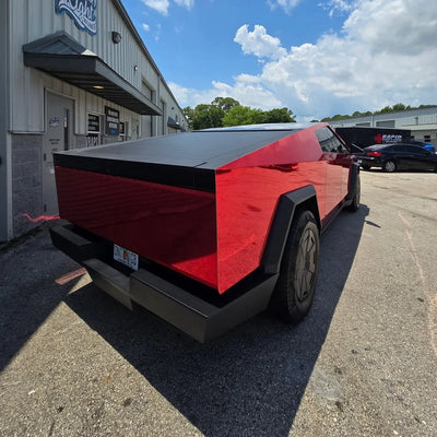 Cherry Red Mirror Chrome vinyl wrap Tesla with a vivid reflective red finish.