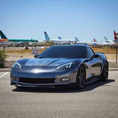 Corvette featuring a bold Jet Black Mirror Chrome vinyl wrap finish.