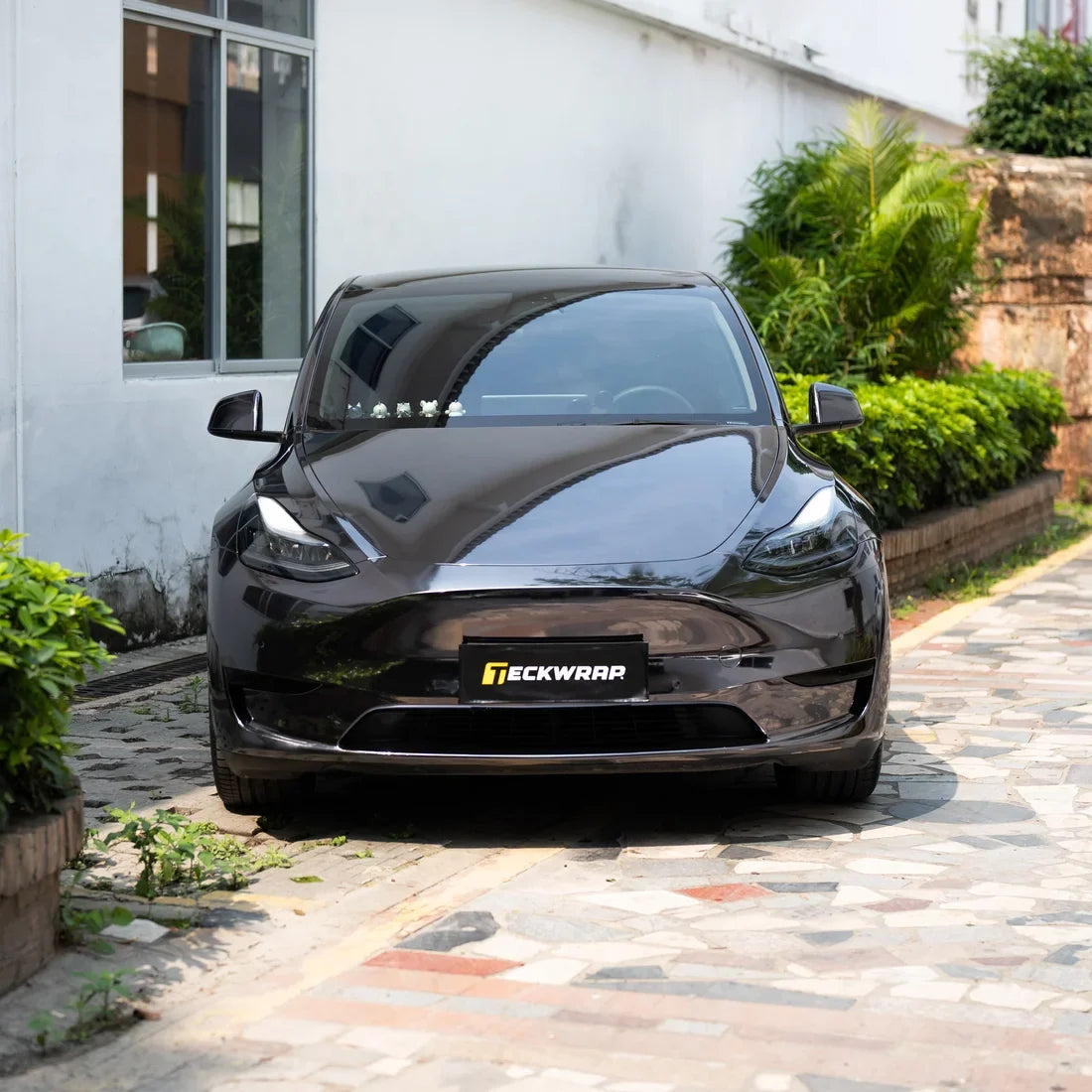 Tesla finished with a dark Jet Black Mirror Chrome vinyl wrap.
