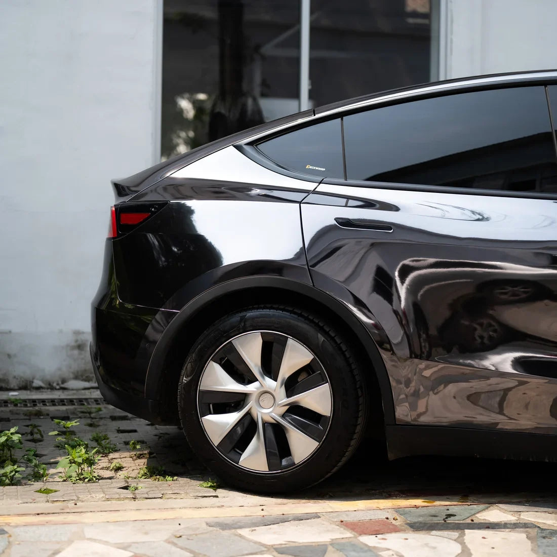 Tesla showing off its glossy Jet Black Mirror Chrome vinyl wrap.
