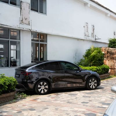 Black Tesla with a mirror-like Jet Black Chrome vinyl wrap finish.