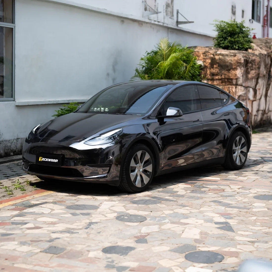 Jet Black Mirror Chrome Tesla showcasing its sleek reflective finish.