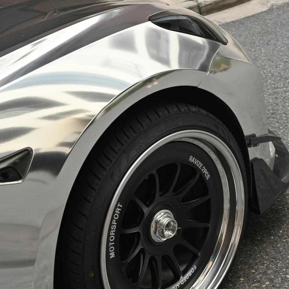 Tesla featuring a mirror-like Jet Black Chrome carbon vinyl wrap.