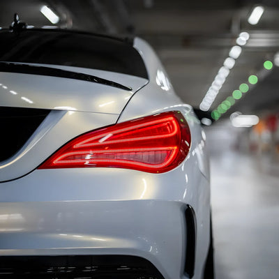 Rear view of a gold pearl white chameleon vinyl wrap on car