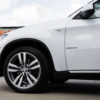 Close-up side view of frosted pearl white chameleon wrap on car